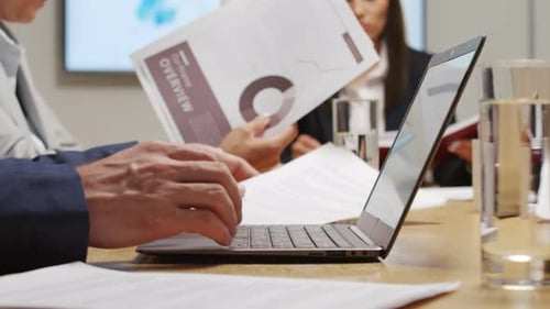 Business Team Reviewing Documents at Conference Table
