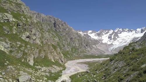 Beautiful Landscape Mountains Peaks Snow. River in Mountain Valley