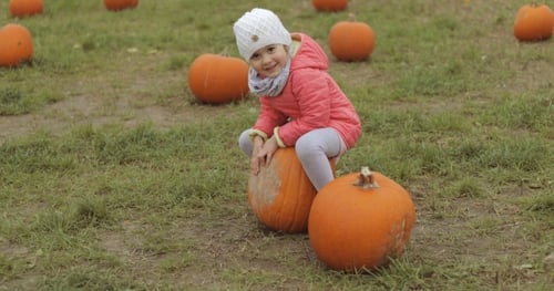 Playful Child Having Fun in Autumnal Garden