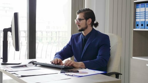 of Angry Business Person in the Office Talking on Mobile Phone