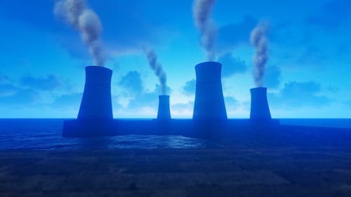Industrial Cooling Towers Emitting Smoke by Ocean under Blue Sky