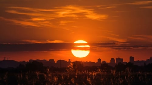 Urban Cityscape Sunset Behind Buildings and Clouds