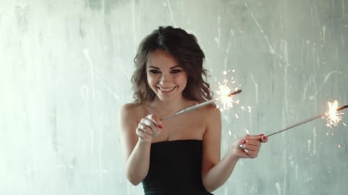 Smiling Woman with Sparklers at Celebration