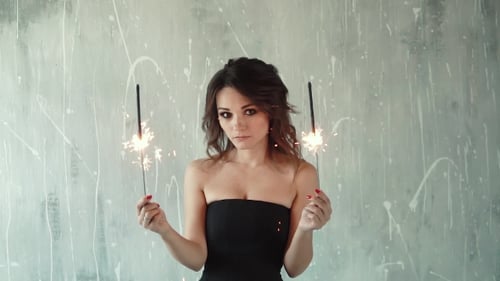 Woman Holds Sparklers in Celebration