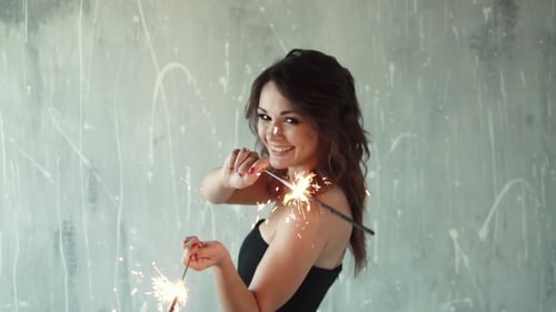 Smiling Woman with Sparklers at Party