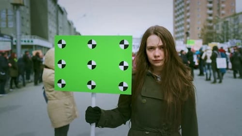Woman Holding Chroma Key Sign in Crowd