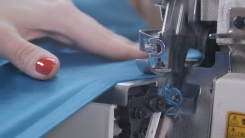 Ein Quilter sticht geschnittene Stücke aus buntem Stoff für ein Quilt-Top