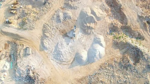 Aerial view of trash yard with parked bulldozers, Pag island, Croatia
