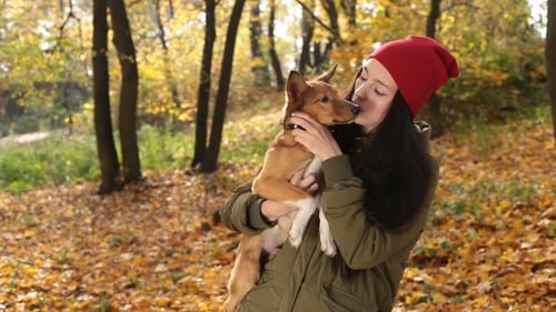Tender Scene of Woman with Dog in Autumn Park