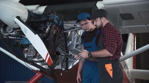 Two Flight Mechanics Doing a Pre Flight Check
