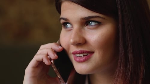 Beautiful Business Woman Talking on the Phone Smiling and Talking About Her Trip on Vacation. .