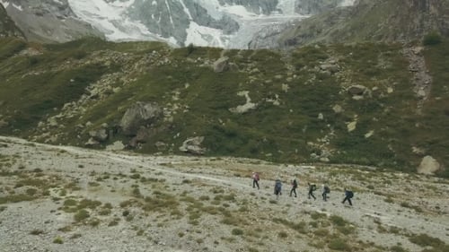 Traveling Group Walking on Mountain Trail Aerial View. Hiking Mountain