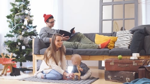 Happy Family Celebrates Christmas Together at Home
