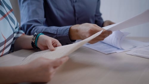 Saleswoman in an Office Is Giving Agreements, Certificates and Other Documents To Customers