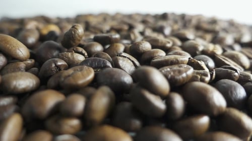 Close-Up of Roasted Coffee Beans Falling