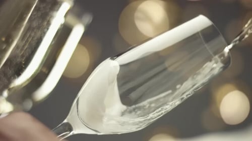 Champagne Poured into Flutes for Celebratory Occasion