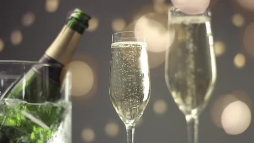 Hand Reaches For Champagne in Sparkling Scene