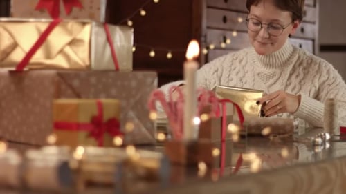 Woman Wrapping Gifts for Christmas at Home
