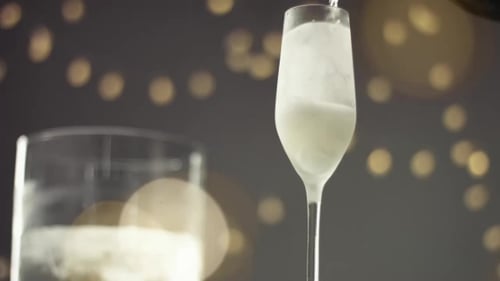 Champagner in ein Flötenglas gießen