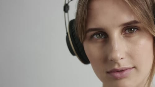 Young Woman Smiling Wearing Headphones in Close Up