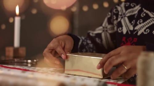 Gift Wrapping by Candlelight for Christmas Celebration