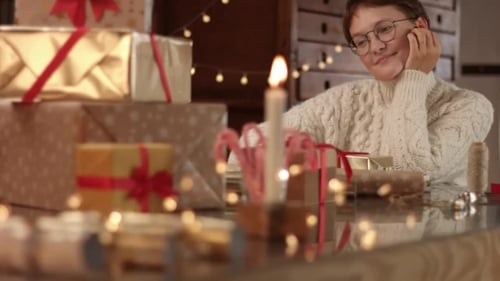 Smiling Young Adult Wrapping Gifts at Home