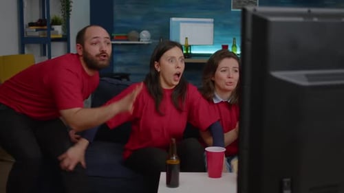 Friends Excitedly Watching Television in Living Room