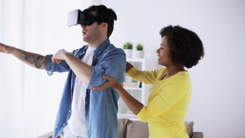 Man Exploring VR with Guiding Friend at Home