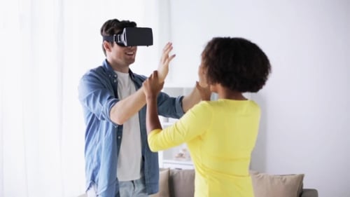 Man Experiencing Virtual Reality with Friend at Home