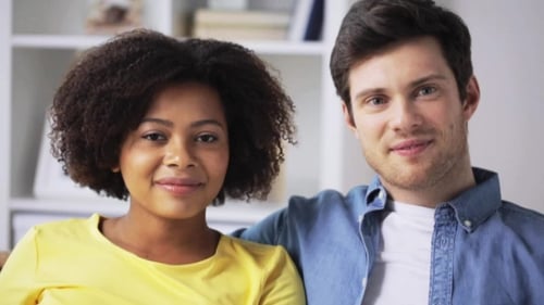 Attractive Couple Smiling in an Indoor Setting