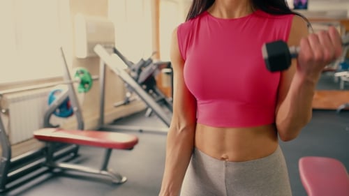 Athletic Young Woman Lifting Barbell Bar in Gym. 4 k