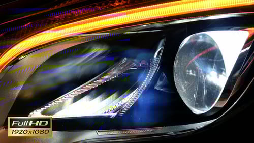 Car Headlight Turning On in the Dark