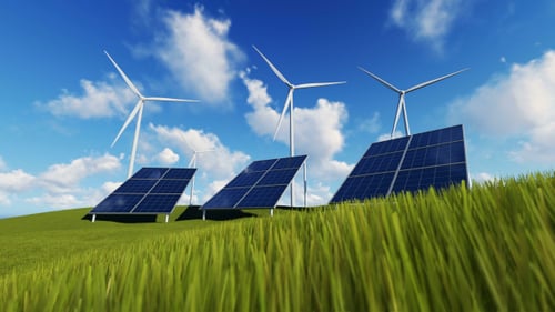 Wind Turbines and Solar Panels on a Green Hill