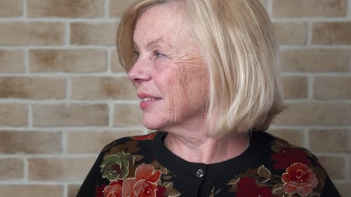 Senior Woman Smiling Portrait Against a Brick Wall