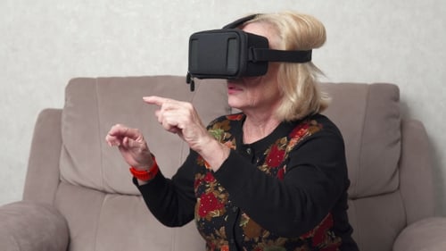 Senior Woman Enjoys Virtual Reality Experience at Home