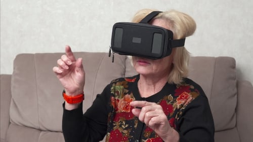 Senior Woman Using VR Headset at Home