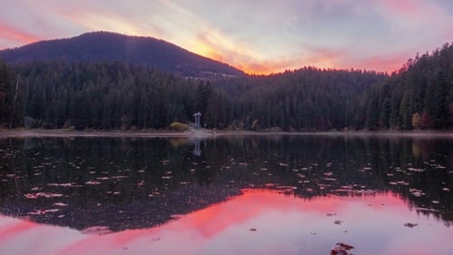 Autumn Sunset at Mountain Lake with Colorful Trees in the Forest