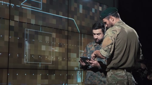 Men Analyze Data in a Futuristic Control Room