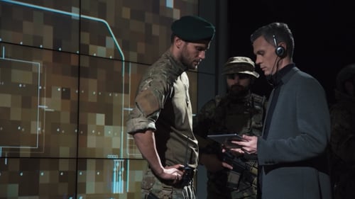 Military Men Reviewing Data in Dark Control Room