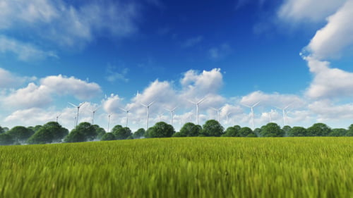 Wind Turbines Rotating in a Green Field with Blue Sky