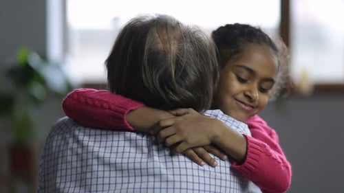 Loving Girl Embracing Grandfather with Affection