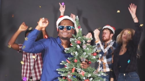 Friends Celebrate Christmas with Tree and Confetti