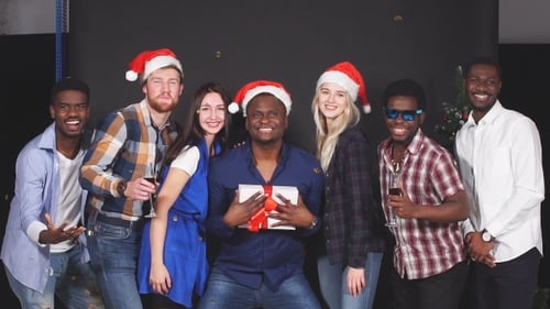 Friends Celebrating Christmas Eve in Studio with Gifts