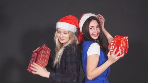 Happy Women with Christmas Gifts Smiling