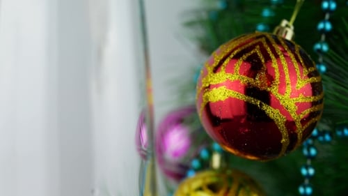 Bubbles in Champagne next to Christmas Ornaments