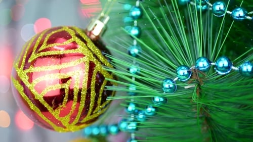 Red and Gold Christmas Ornament Hanging on Tree