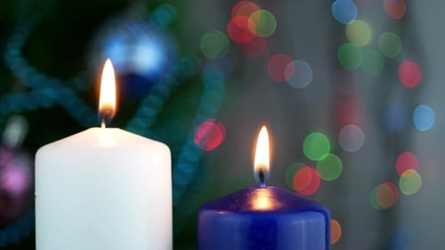 Candles Burning Brightly in Front of Christmas Tree