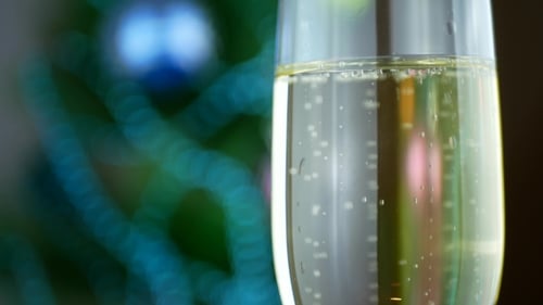 Sparkling Champagne Glass With Defocused Christmas Tree