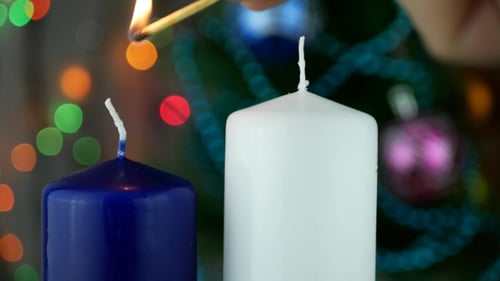Lighting Christmas Candles in Festive Setting