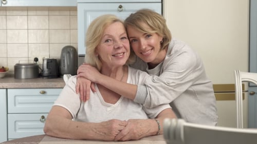 Smiling Senior and Young Women in Kitchen
